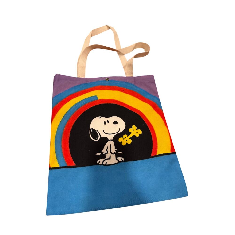 Snoopy canvas tote bag with rainbow and yellow flower graphic and